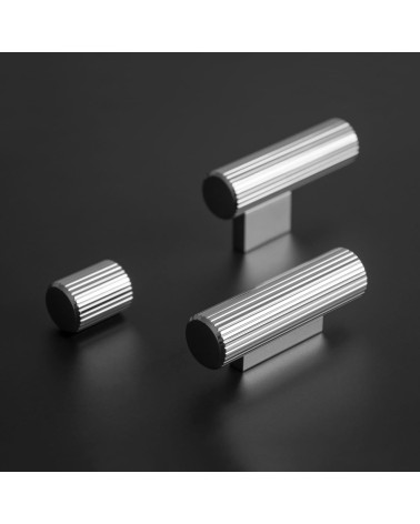 Polished chrome AVANTI T-bar furniture knob designer handle placed on a dark surface