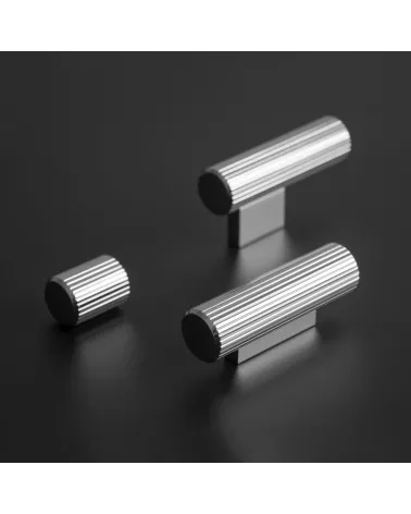 Polished chrome AVANTI T-bar furniture knob designer handle placed on a dark surface