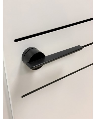 JUMELLE black door handle design handle top angled view mounted on a door