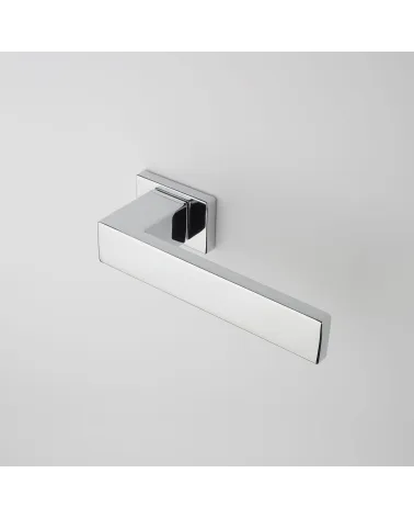 PINA polished chrome door handle design angled top view mounted on a door