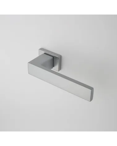 PINA satin chrome door handle designer handle angled top view mounted on a door