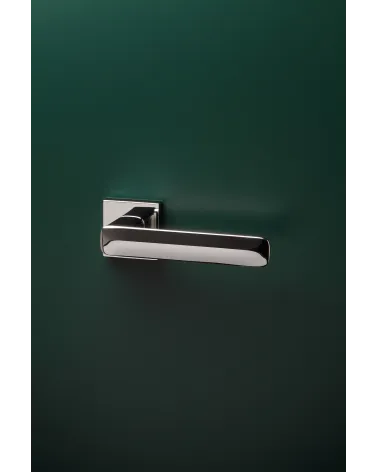 Polished chrome STELLA design door handle mounted on a door