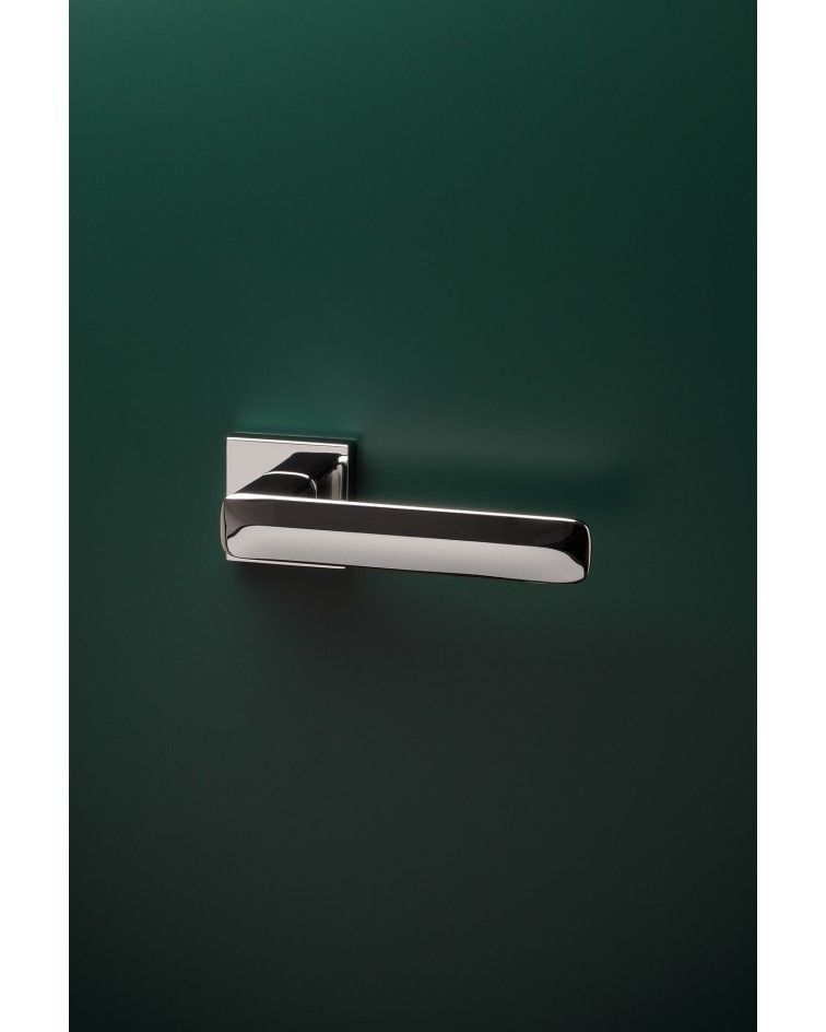 Polished chrome STELLA design door handle mounted on a door