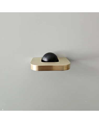 Polished gold ISA XS furniture handle designer handle top view with black ball on grey background