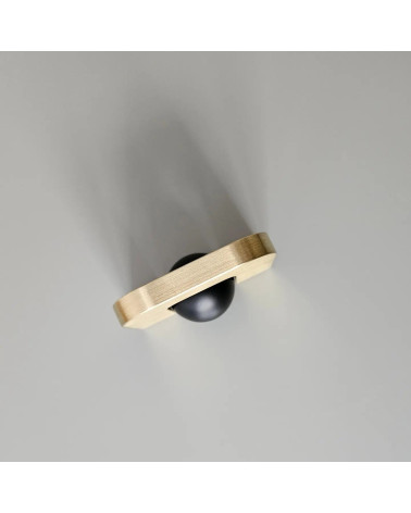 Polished gold ISA XS furniture handle designer handle top angled view with black ball on grey background