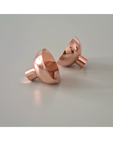 Copper LUNA M furniture knob design handle profile view positioned on a plate