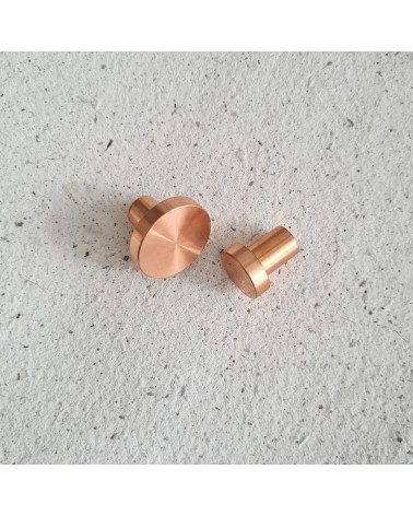 Brass NENA furniture knob design handle positioned side by side on a flat surface