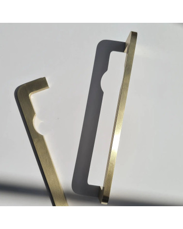 ISA DOT brass furniture handle design placed vertically on a grey surface