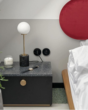 TOVE matte gold furniture knob design handle front view installed on a bedside table in a bedroom