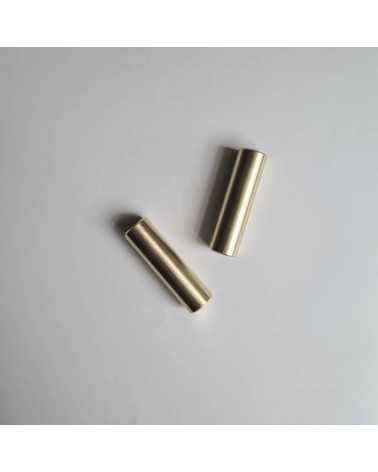 SIV M brass furniture handle designer handle top view one horizontal and the other tilted on a light surface