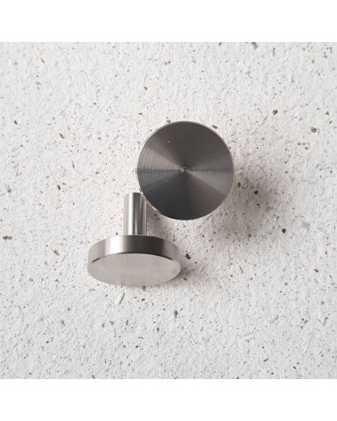 NENA M polished chrome furniture knob designer handle placed on a cement surface