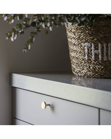 NENA furniture knob designer handle angled view mounted on a cabinet