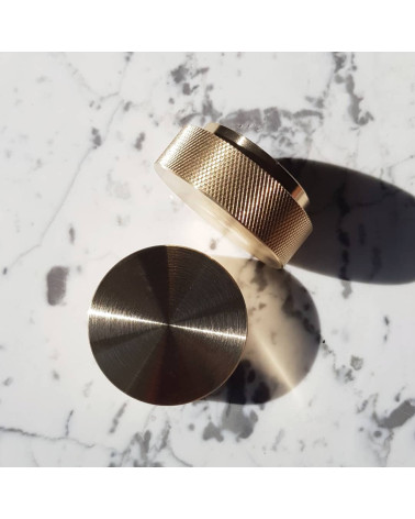 Matte gold TOVE furniture knob designer handle top view slightly angled placed on a white marble surface