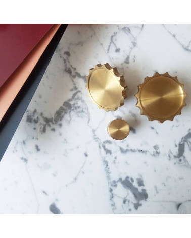 LEXI polished gold furniture knob designer handle placed on a marble plate