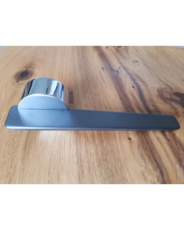 JUMELLE zamak door handle design handle side view placed on a plate