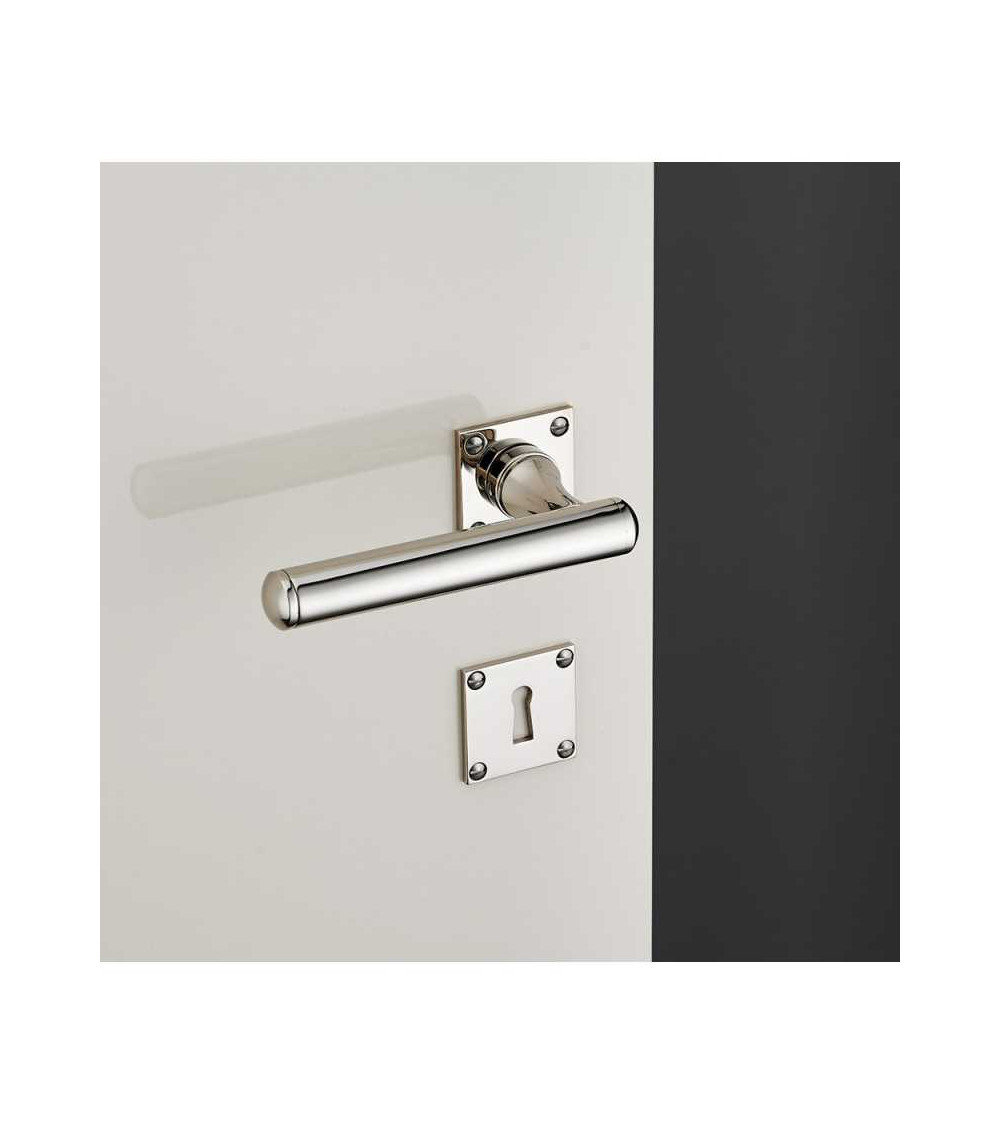 Rounded brass door handle set on square rose