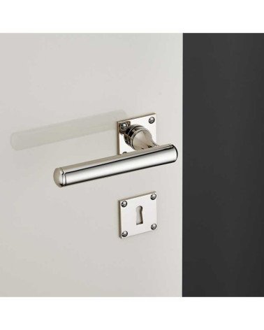 Rounded brass door handle set on square rose