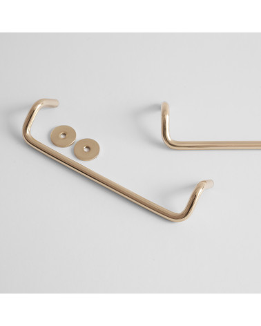 AVA M polished gold varnished furniture handle designer handle with washers on a background