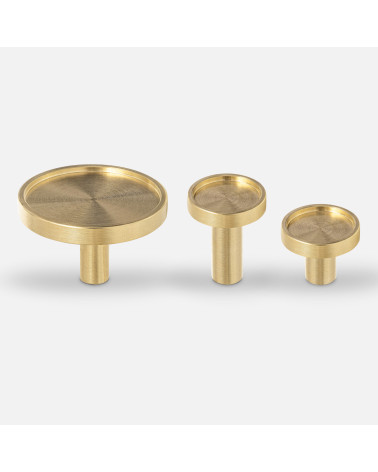 Brass furniture knob INA designer handle aligned horizontally on white surface