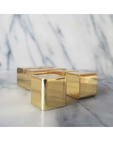 Brass ODETE furniture knob LANA S design handle close-up view placed on grey-veined white marble captured slightly from the side