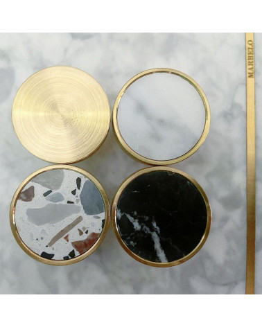 Brass furniture knob 01 design handle placed on a marble surface with other knobs