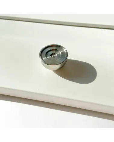 Stainless steel furniture knob model 02 design handle placed on an illuminated surface casting a shadow
