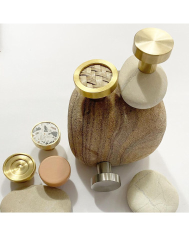 Brass furniture knob 02 design handle arranged on a stone