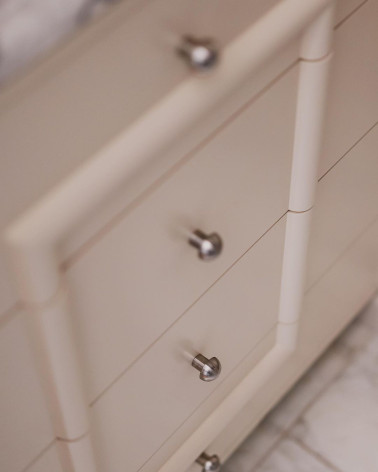 Stainless steel furniture knob 03 designer handle tilted top view on a bathroom cabinet