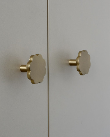 Brass furniture knob Flower 08 designer handle side view installed on a cupboard