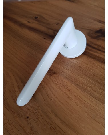 White Spark designer door handle angled top view placed on a plate