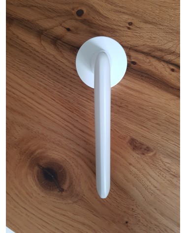 White Spark designer door handle side view placed on a plate