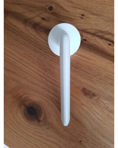 White Spark designer door handle side view placed on a plate