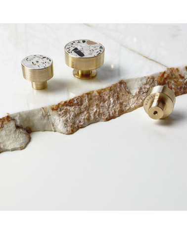 Brass and Terrazzo furniture knob designer handle in various sizes on a marble surface