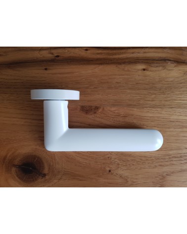 White Spark designer door handle side view placed on a plate