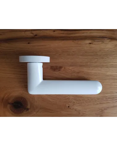 White Spark designer door handle side view placed on a plate