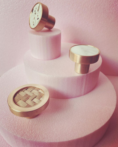 Brass and Terrazzo furniture knob designer handle displayed on a pink stand