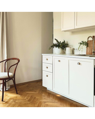 Brass and Terrazzo furniture knob designer handle fitted on furniture in a kitchen