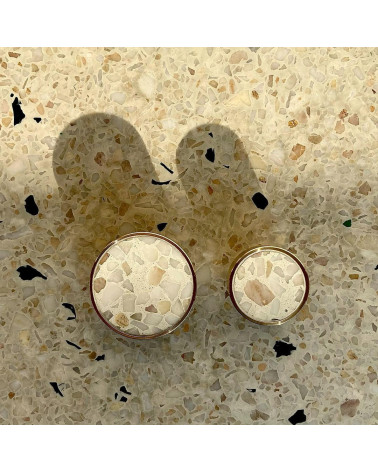 Brass and Terrazzo furniture knob designer handle top view aligned on a terrazzo surface