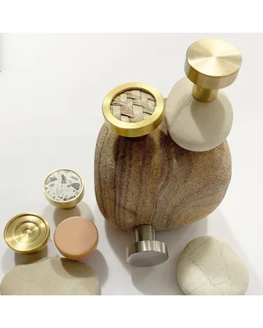 Brass and marine herbarium furniture knob designer handle presented on a stone