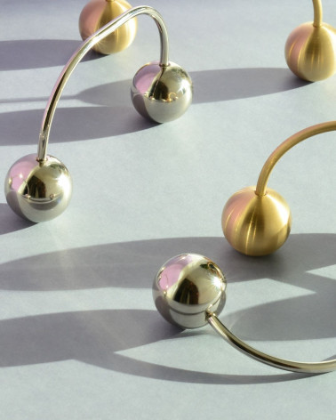 Brass furniture handle 10 designer handle close-up view arranged diagonally on a white surface