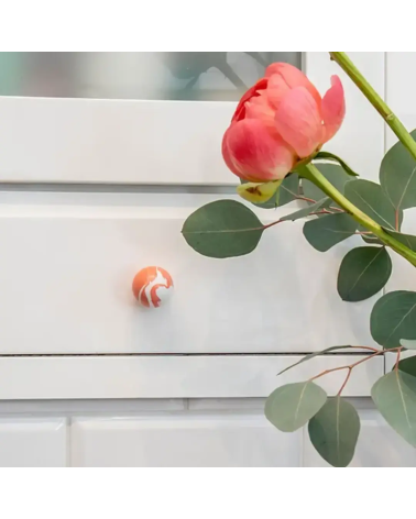 Cherry red beech wood furniture knob designer handle mounted on furniture with a rose placed on top
