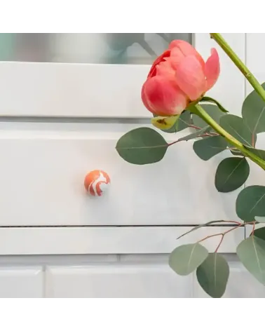 Cherry red beech wood furniture knob designer handle mounted on furniture with a rose placed on top