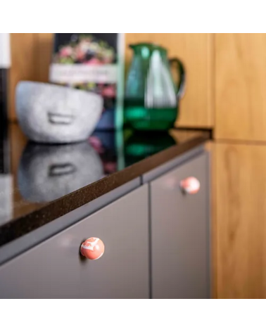 Cherry red beech wood furniture knob designer handle installed on a kitchen cabinet door
