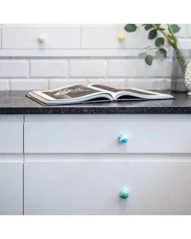 Rich green beech wood furniture knob designer handle front view installed on a chest of drawers
