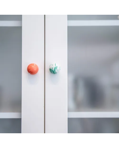 Rich green beech wood furniture knob designer handle fixed on a glass cabinet