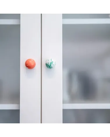 Rich green beech wood furniture knob designer handle fixed on a glass cabinet