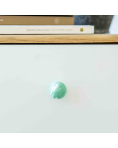 Rich green beech wood furniture knob designer handle front view mounted on a piece of furniture