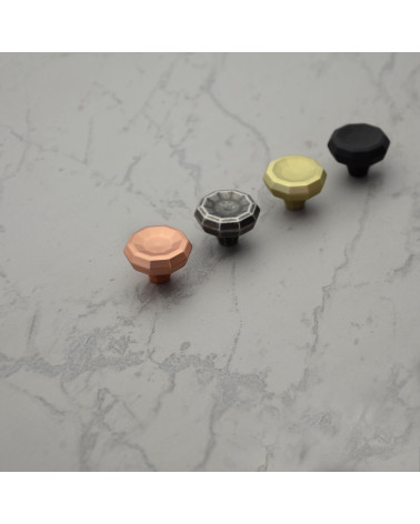 CAMPANA furniture knob design handles aligned diagonally on a light surface with a marbled pattern