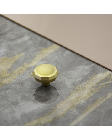 CAMPANA matt gold furniture knob designer handle placed on a flat surface with a textured background