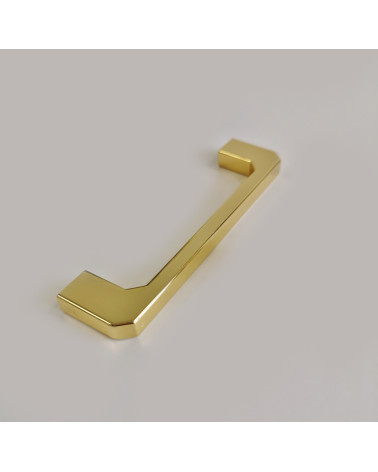 CAMPANA polished gold furniture handle designer handle placed on a grey surface